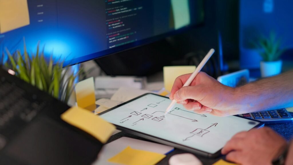 A freelancer creating a visual workflow plan on a tablet at their desk, demonstrating how freelance workflow management tools support project organization.