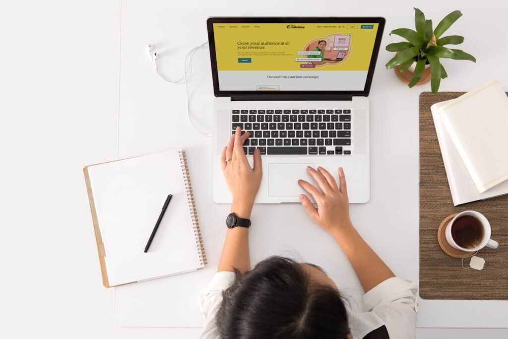 A freelancer working at a desk with a laptop and a cup of coffee.