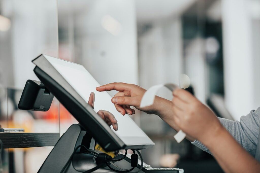 Close-up of a point-of-sale terminal printing a receipt