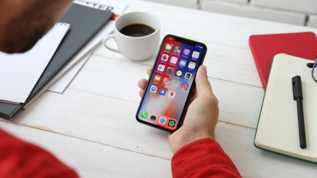 Person holding a smartphone, representing the best apps for freelancers available.