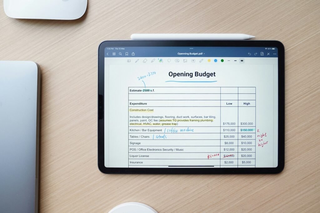 Freelancer checking business expenses on a tablet to see which ones are tax-deductible