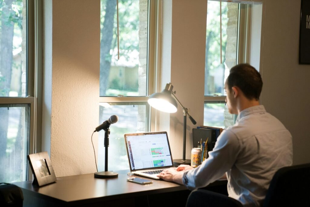 Freelancer in a white shirt working on a laptop after cutting digital distractions