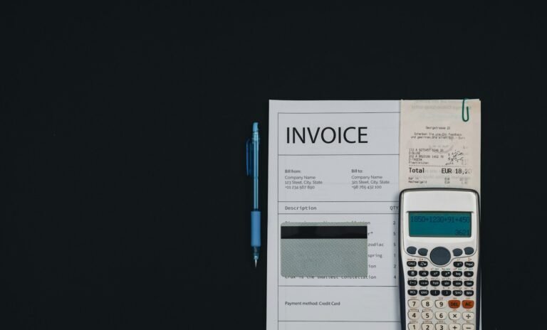 Calculator resting on a piece of paper, representing a freelance billing software cost comparison