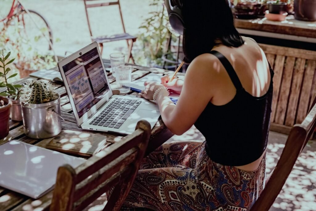 Freelancer at a laptop batching similar tasks together to work more efficiently