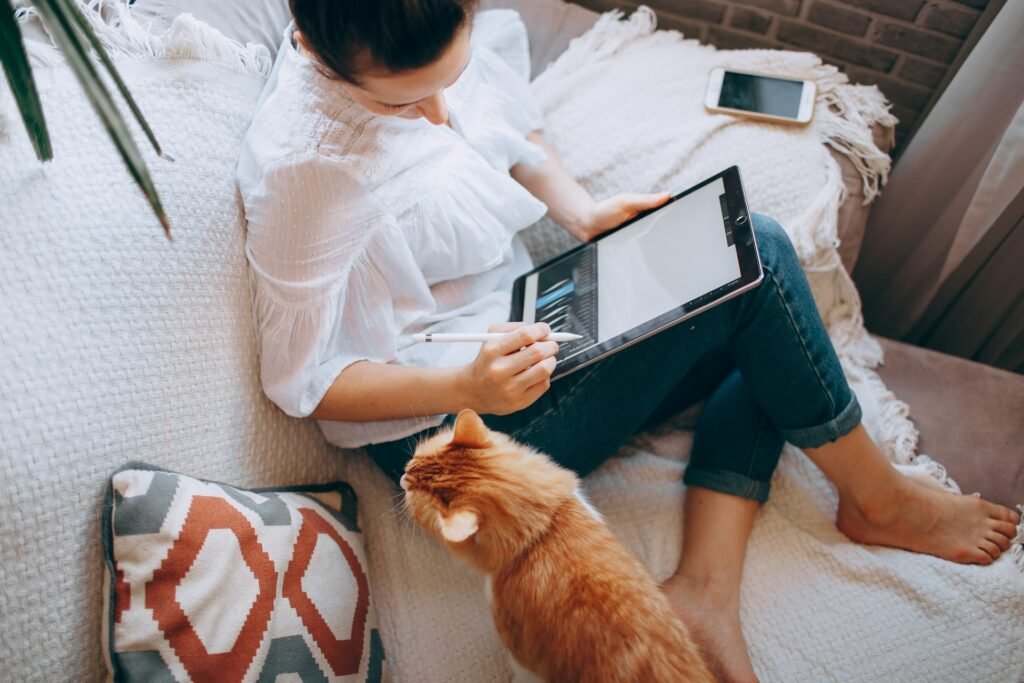 Freelancer using a tablet from bed, letting automation apps run tasks in the background