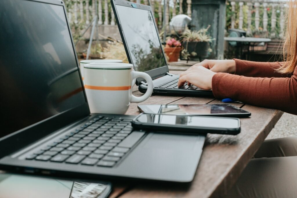 Freelancer using a laptop at a table, working with her productivity tools