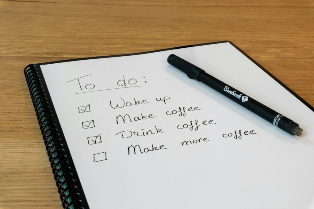 Notepad with a pen resting on top, representing a freelancer's free to-do list and task apps