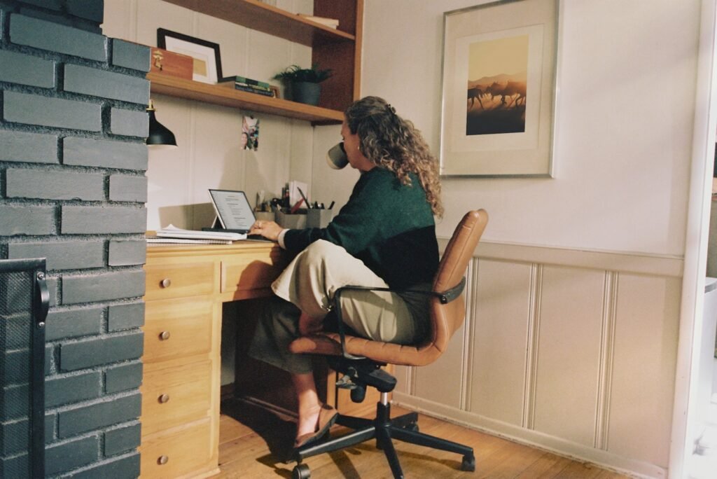 Freelancer working at a desk with a coffee, managing her energy through the day