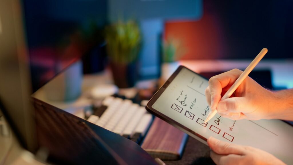 Freelancer writing notes on a tablet with a stylus using a note-taking app