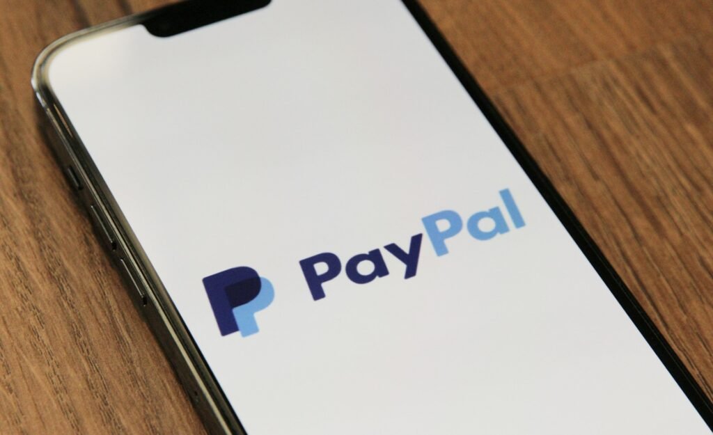 Smartphone showing the PayPal logo, one of the no-subscription options for freelance invoicing