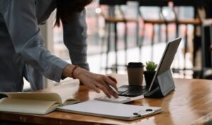 Freelancer at an office desk using a calculator, weighing up the real cost of "free" productivity tools