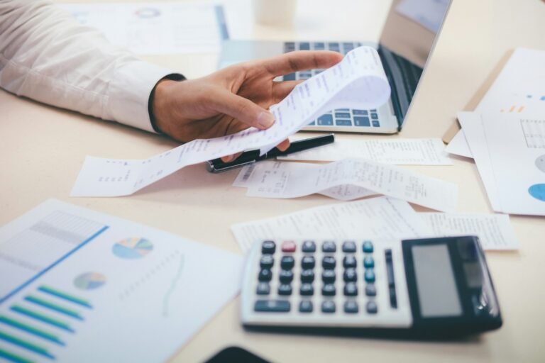 A business manager looking through his receipts with financial documents around him