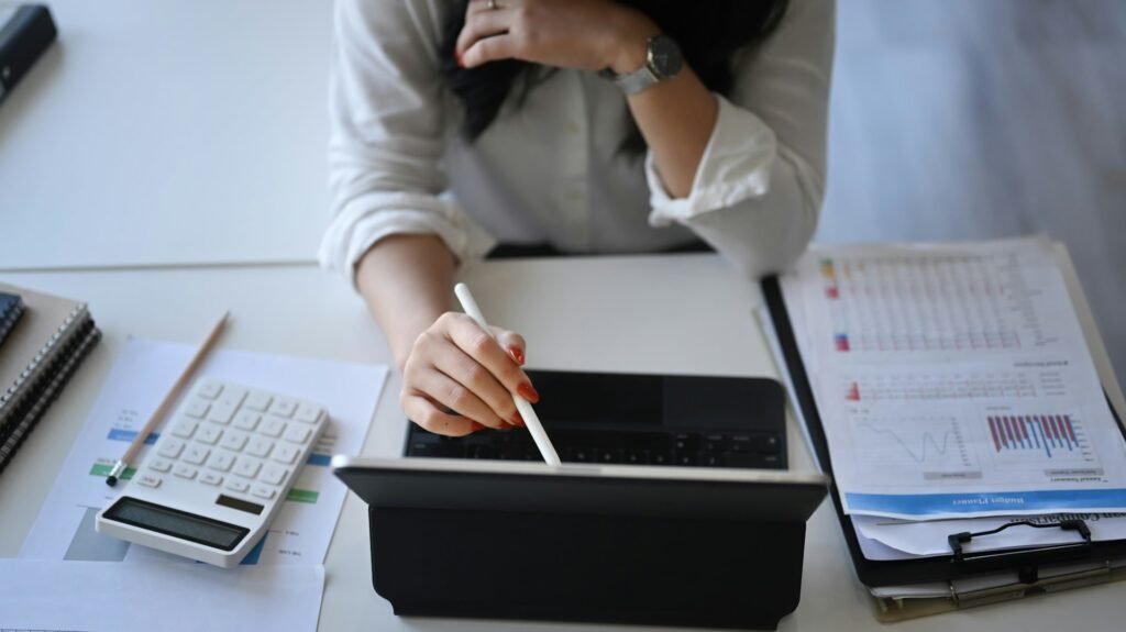 Freelancer analysing financial data on a tablet for small business accounting
