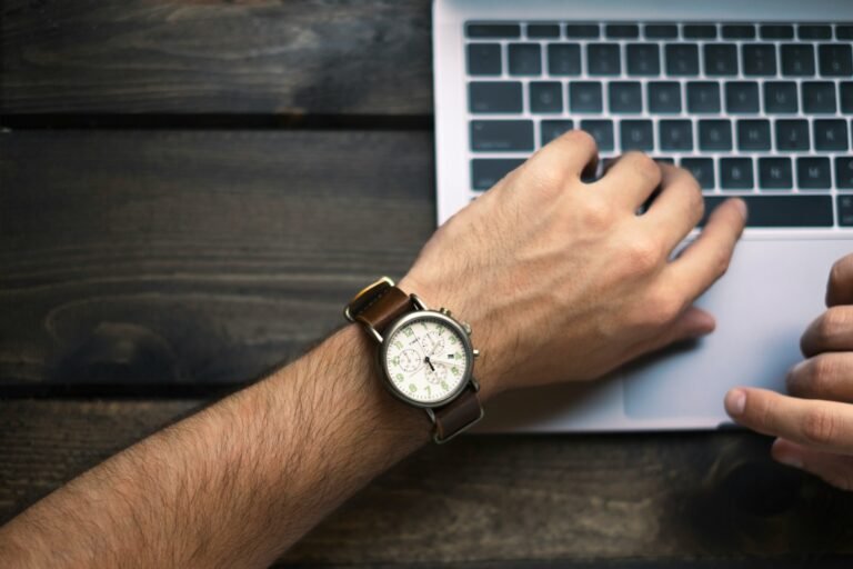 Freelancer checking the time on a wristwatch before starting a time tracking session