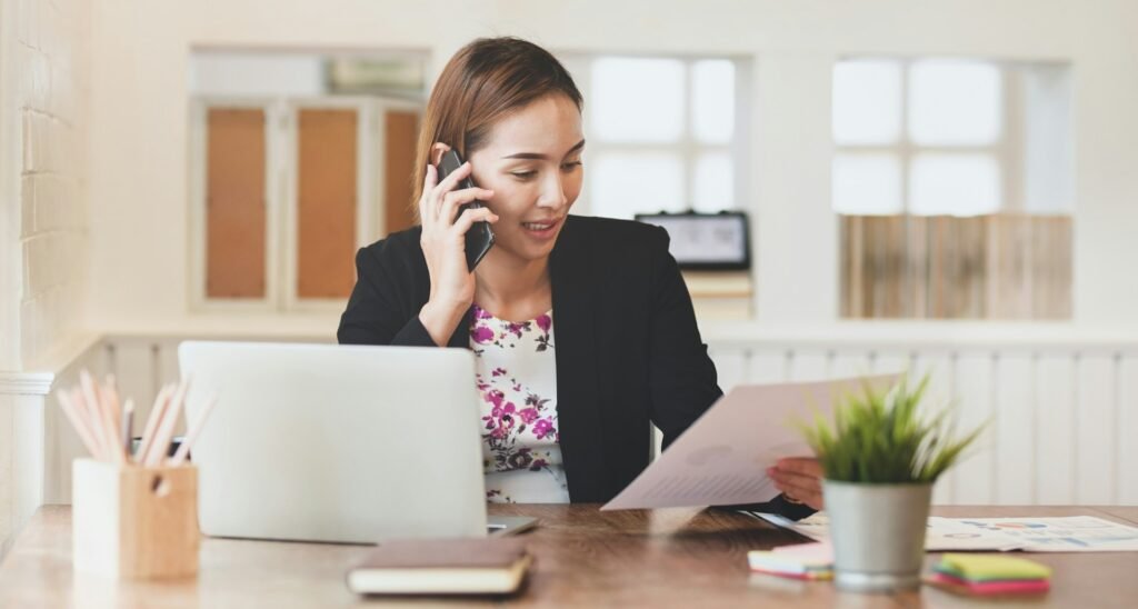 Freelancer discussing contract terms with a client on the phone before starting work
