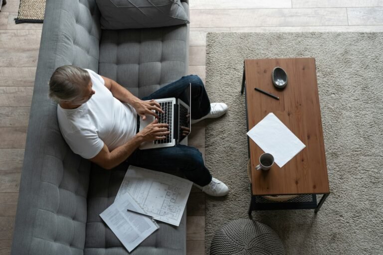 Freelancer working from a home office preparing a pro forma invoice on a laptop