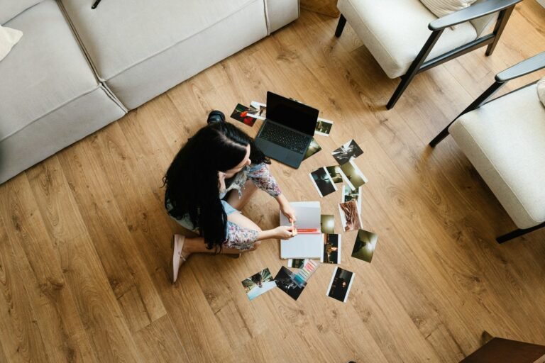 Freelancer sitting on the floor with a laptop surrounded by receipts and paperwork