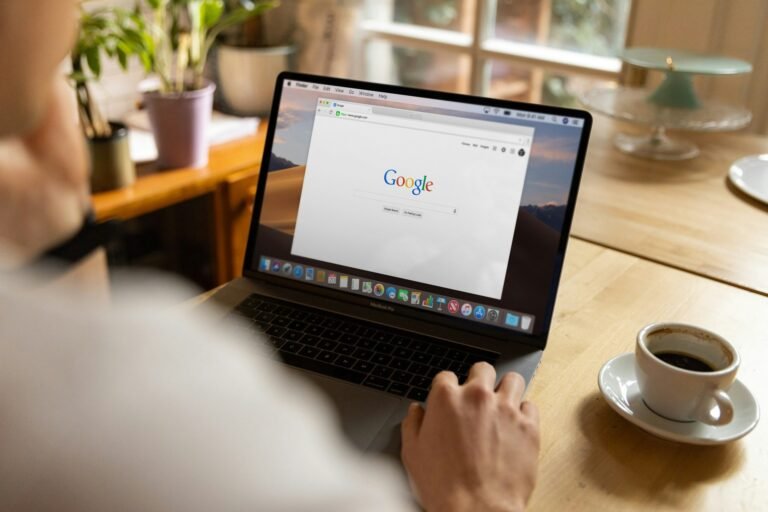 Freelancer using a MacBook Pro to create a Google Docs invoice template