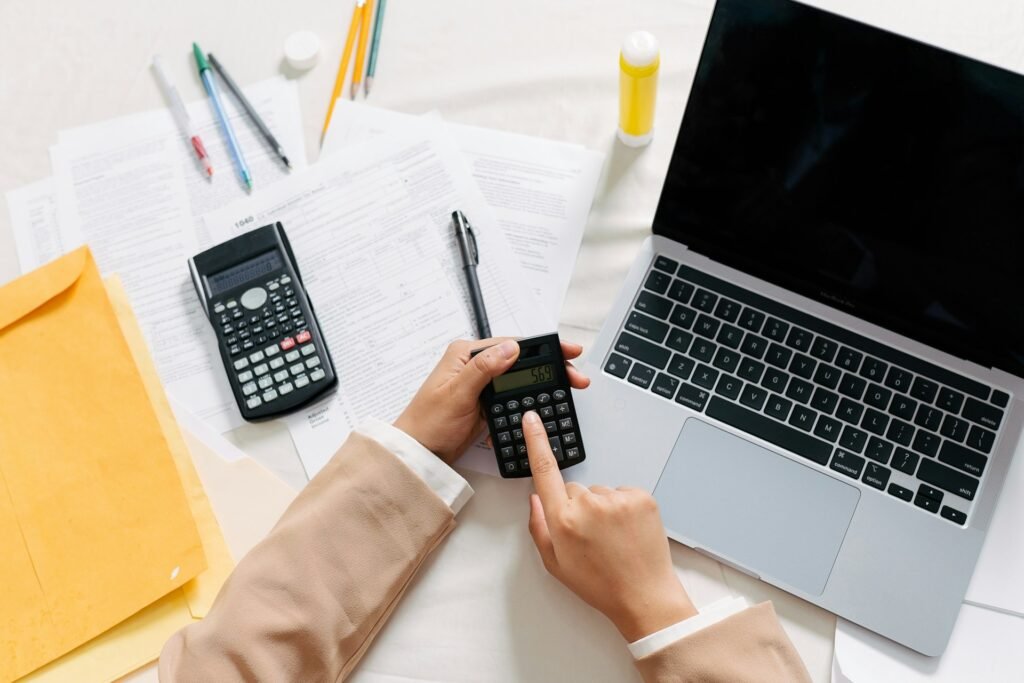 Freelancer working from a home office preparing a pro forma invoice on a laptop