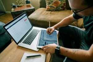 Freelancer working across a laptop and a tablet with a stylus